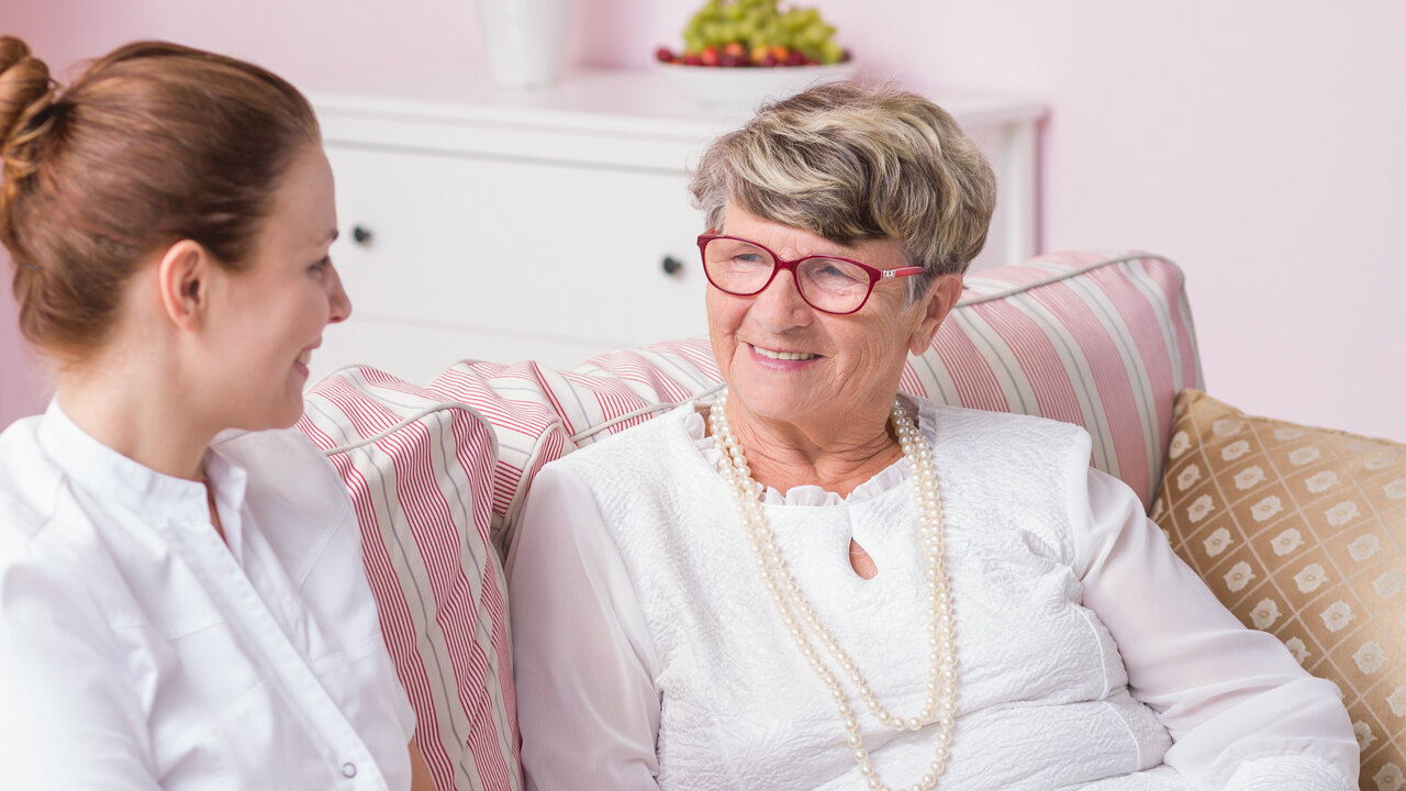 Nurse converses with senior citizen