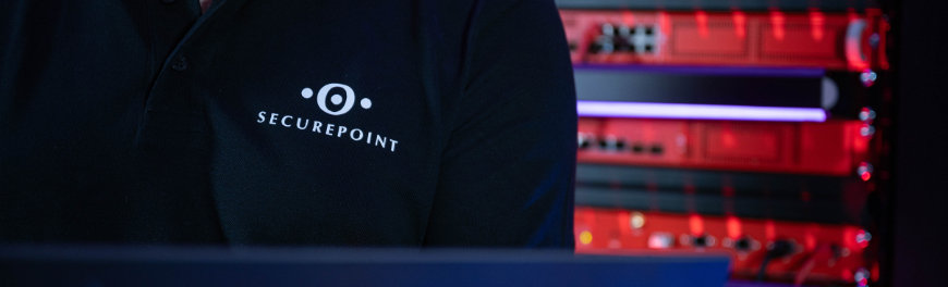 Person steht vor einem Serverschrank. Auf dem Poloshirt ist das Logo von Securepoint.